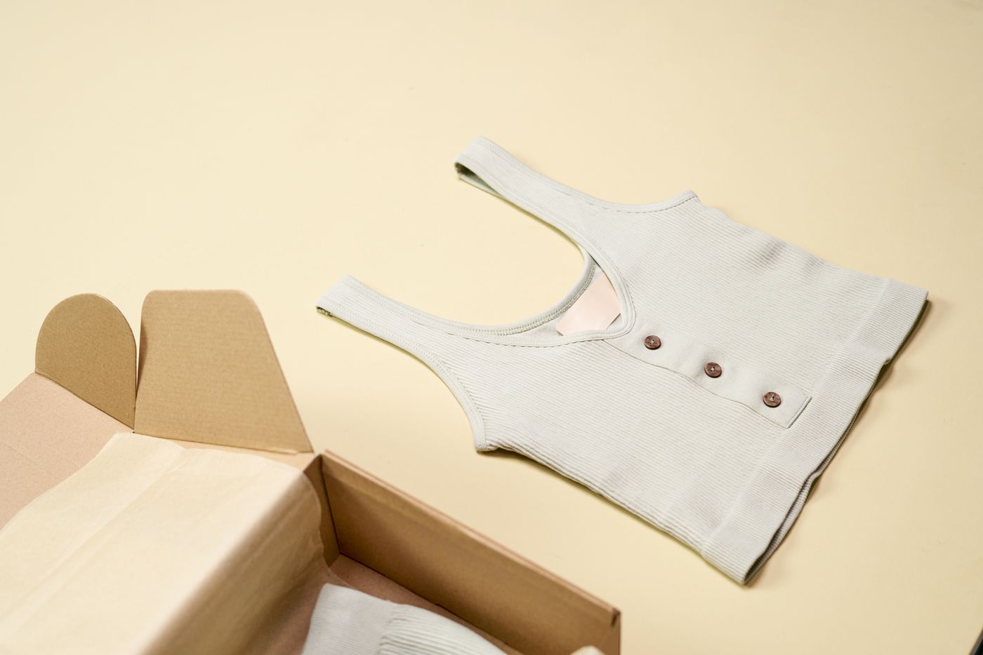 Minimal pastel clothing flat lay with soft textiles and no people