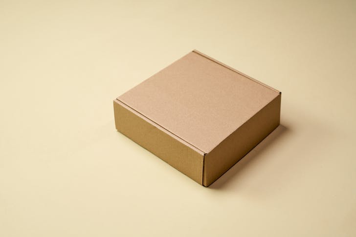 Brown Cardboard Box on White Table