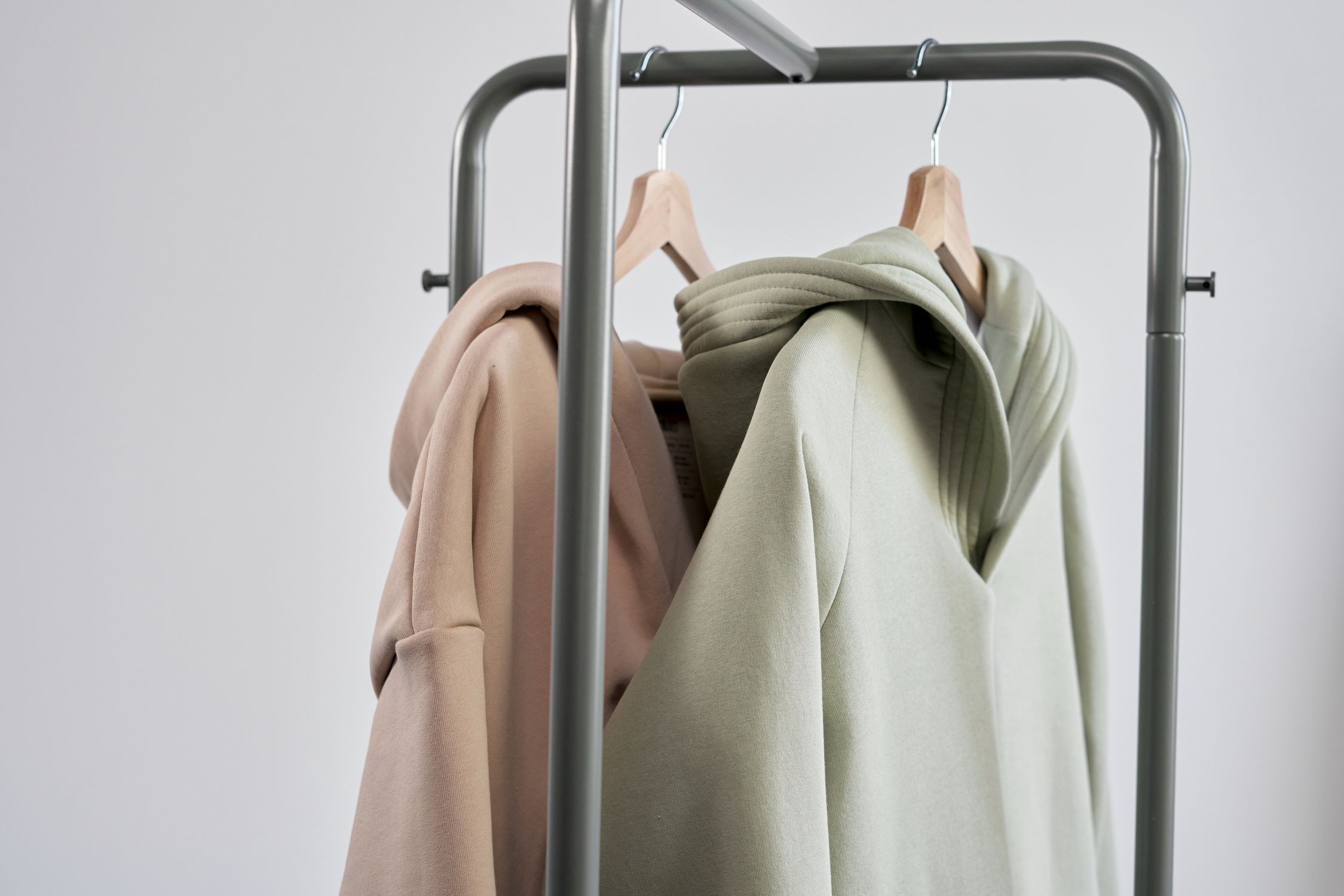 Hoodie Sweaters Hanged on a Clothes Rack · Free Stock Photo