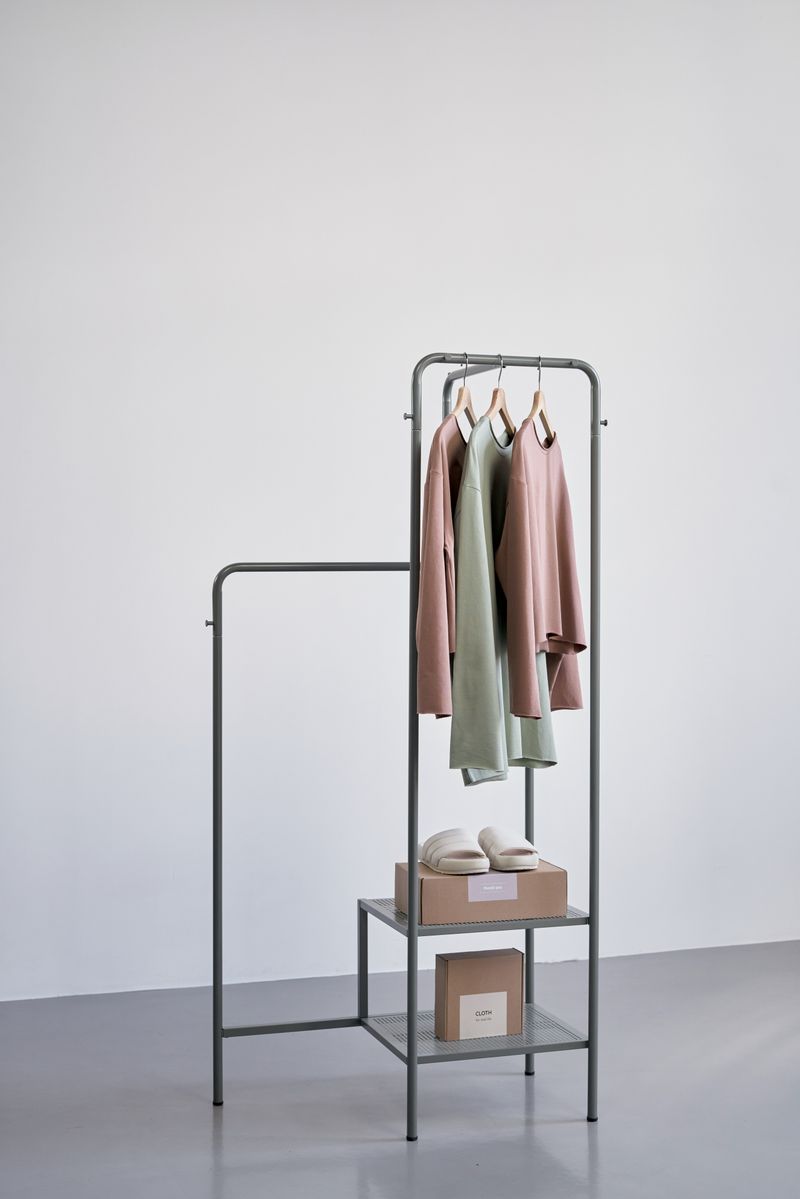 Small clothing rail and shelf in a pale studio — Ron Lach on Pexels