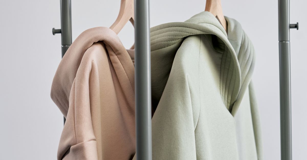 Hoodie Sweaters Hanged on a Clothes Rack · Free Stock Photo