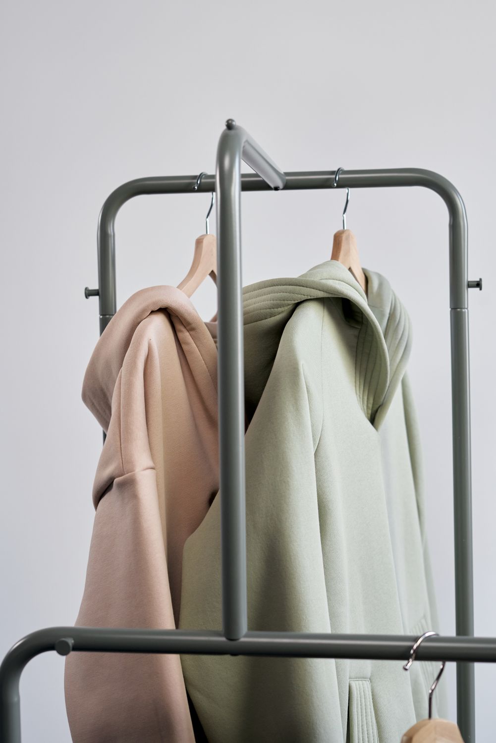 Hoodie Sweaters Hanged on a Clothes Rack · Free Stock Photo