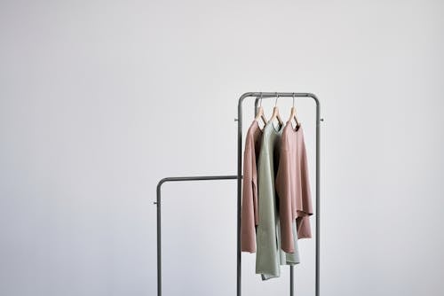 White and Brown Clothes Hanging on Gray Metal Rack