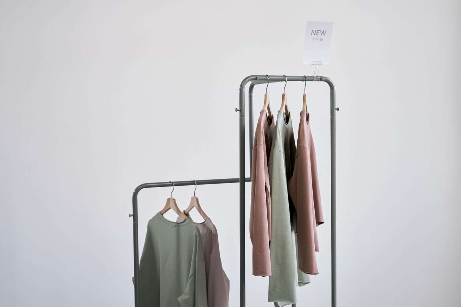 Elegant clothing rack with blouses in a minimalist setting without people