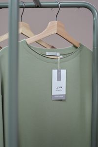 Merino base tee on a wooden hanger — photo by Ron Lach on Pexels