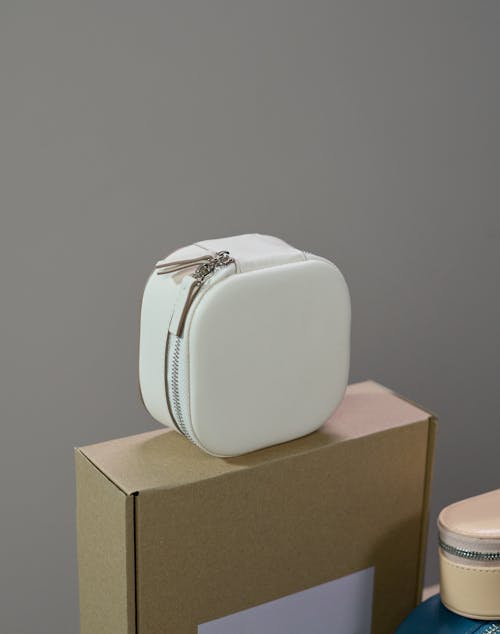 White and Brown Box on Brown Wooden Table