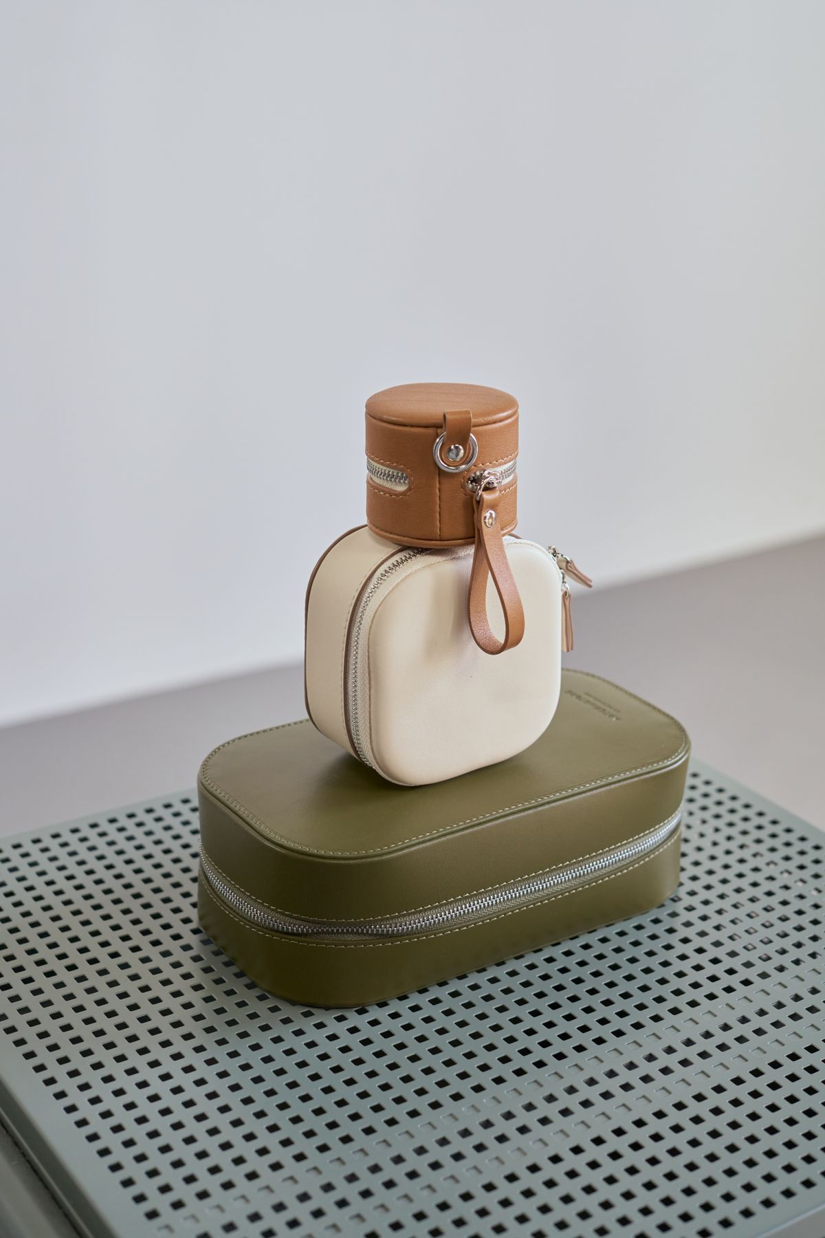 Solène crescent bag stacked with other atelier leather pieces