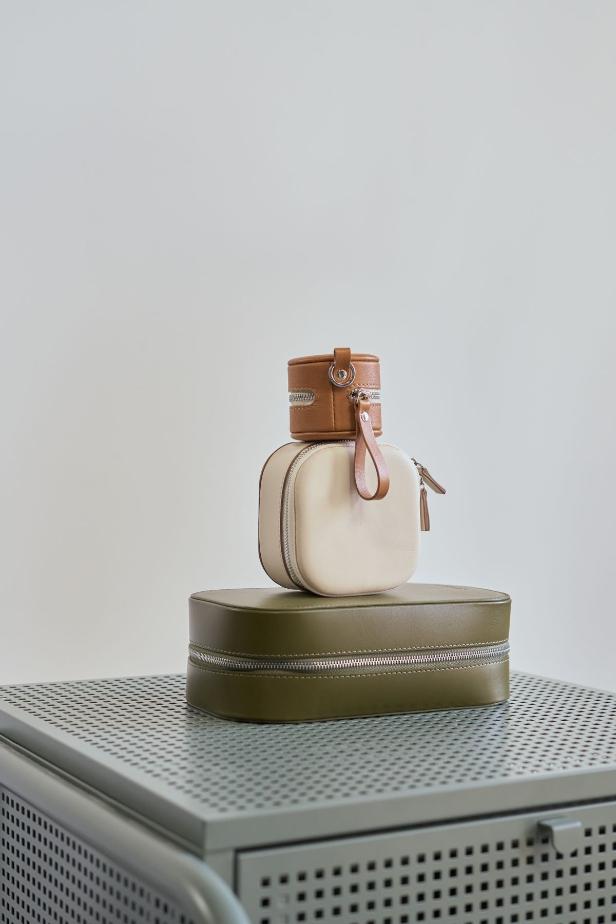 Cortile satchel in cognac leather resting beside a laptop
