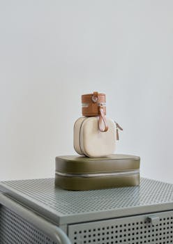 Assorted small handbags on a metal cabinet with a sleek, minimalist style.