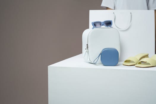 Modern fashion accessories including backpack, sunglasses, and sandals in minimalistic display.