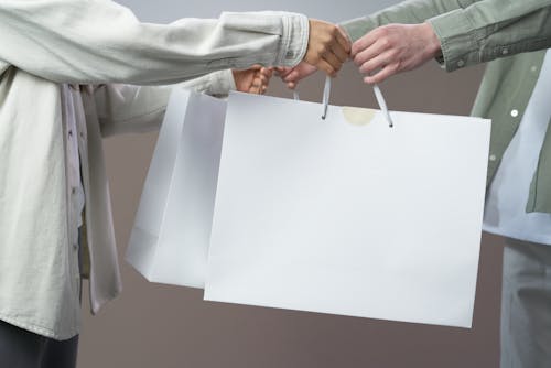 Person in Gray Long Sleeve Shirt Holding White Paper