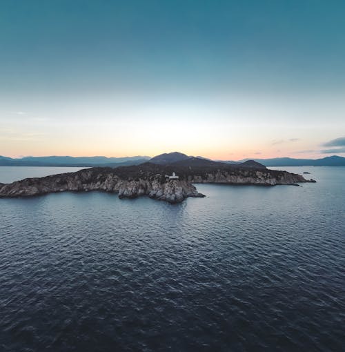 Free Aerial View of an Island on Body of Water Under Blue Sky Stock Photo