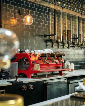 Chic coffee shop interior featuring a vibrant red espresso machine.