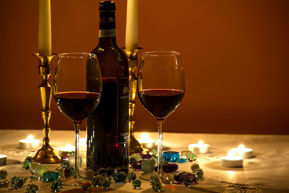 Wine glasses and bottle on a table, representing alcohol after weight loss surgery