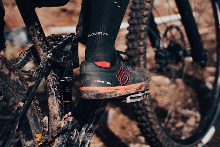 Close-Up Shot Of A Person Wearing A Dirty Five Ten Bike Shoe