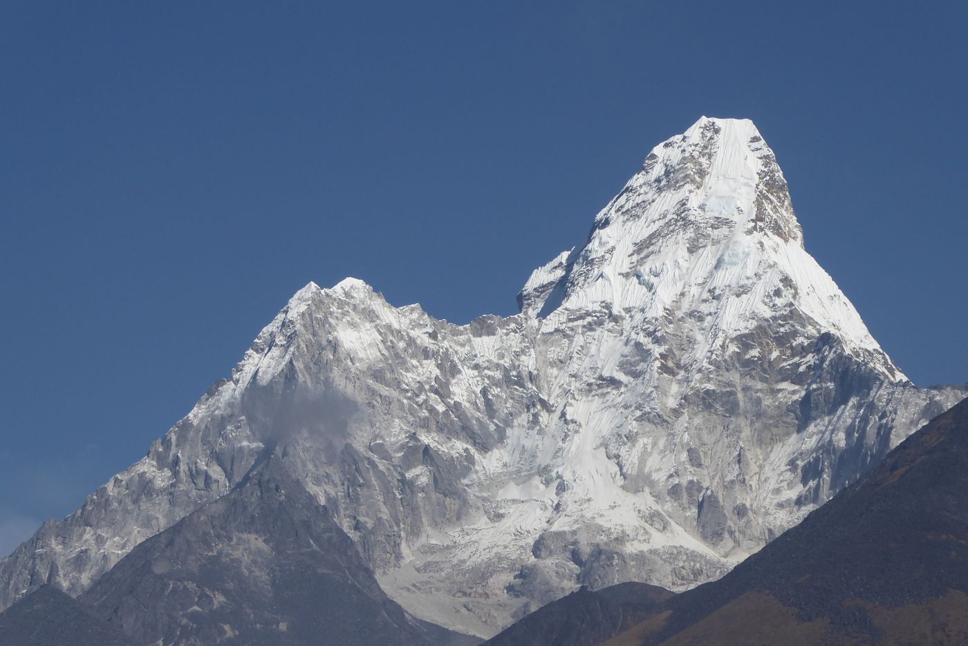 Snow covered summit of Ama Dablam in Nepal under a clear sky
