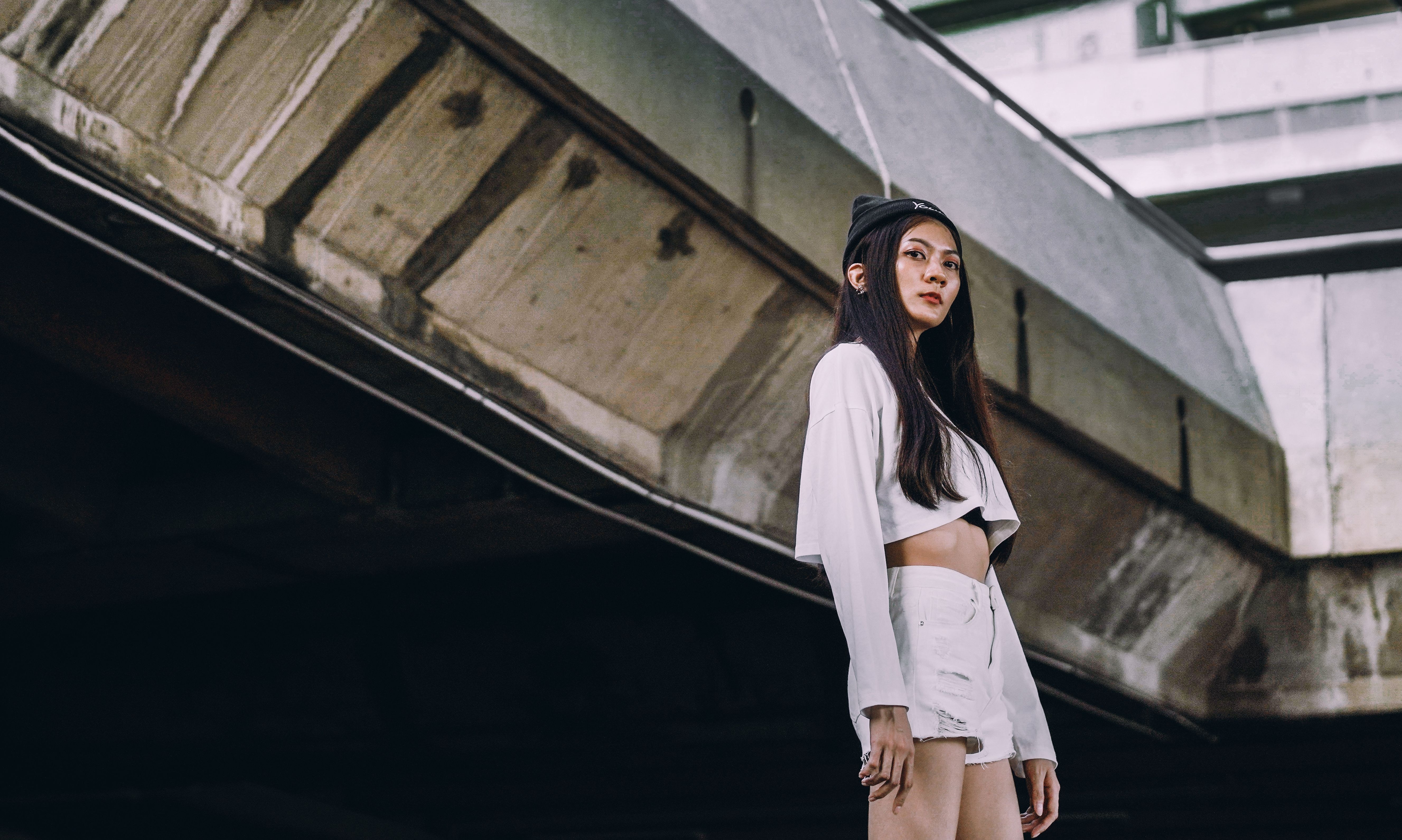 Woman in long tailored shorts and structured top on a city street