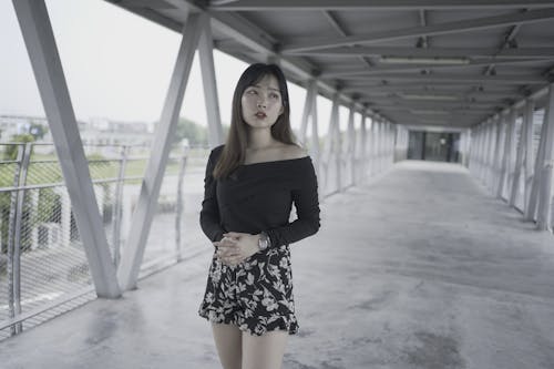A Beautiful Woman in Black Long Sleeves and Floral Skirt