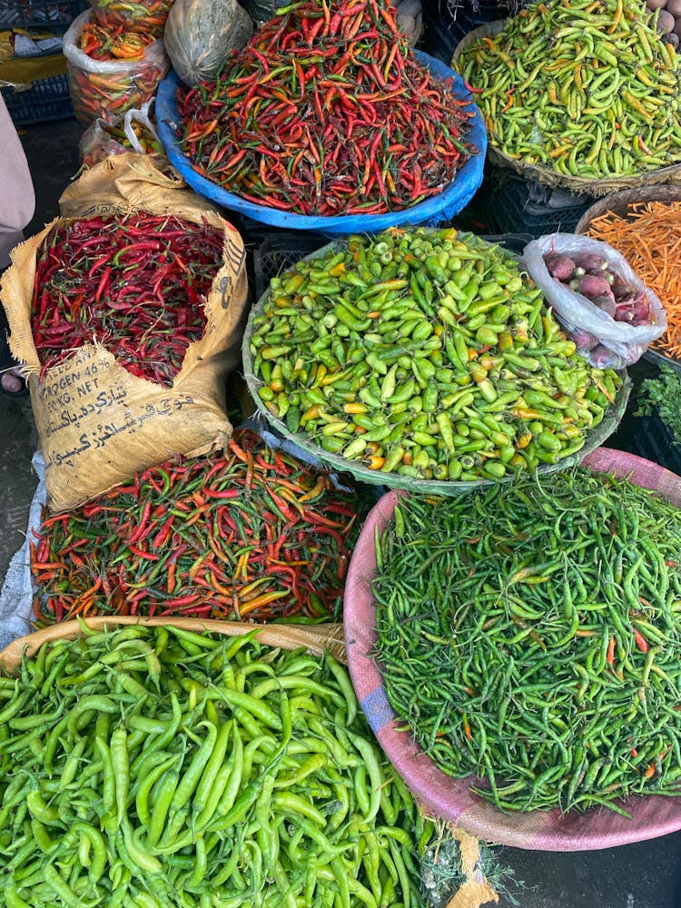 A Bunch Of Green And Red Chili Peppers