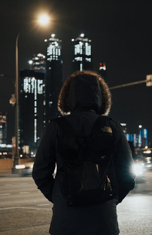 A Back View of a Person Wearing Parka at Night