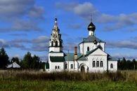 White and Brown Concrete Church Under Cloudy Sky