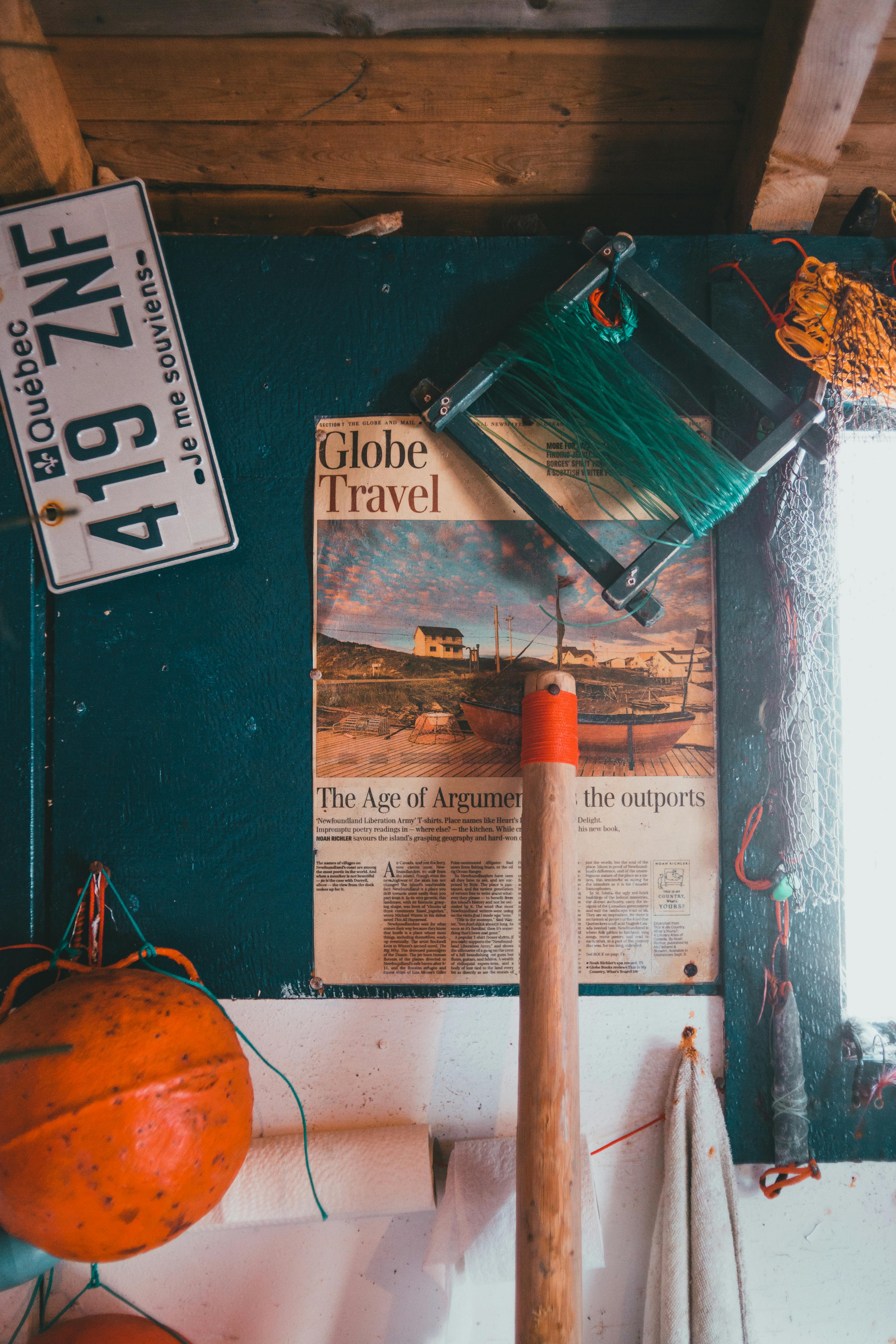 Cozy cabin interior featuring vintage travel posters, fishing gear, and Quebec license plate decor.