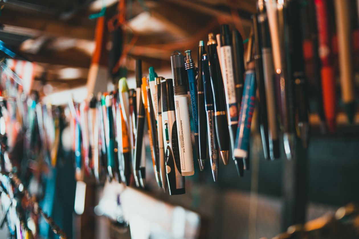Multiple fountain pens arranged on a wooden surface — fountain pen collection