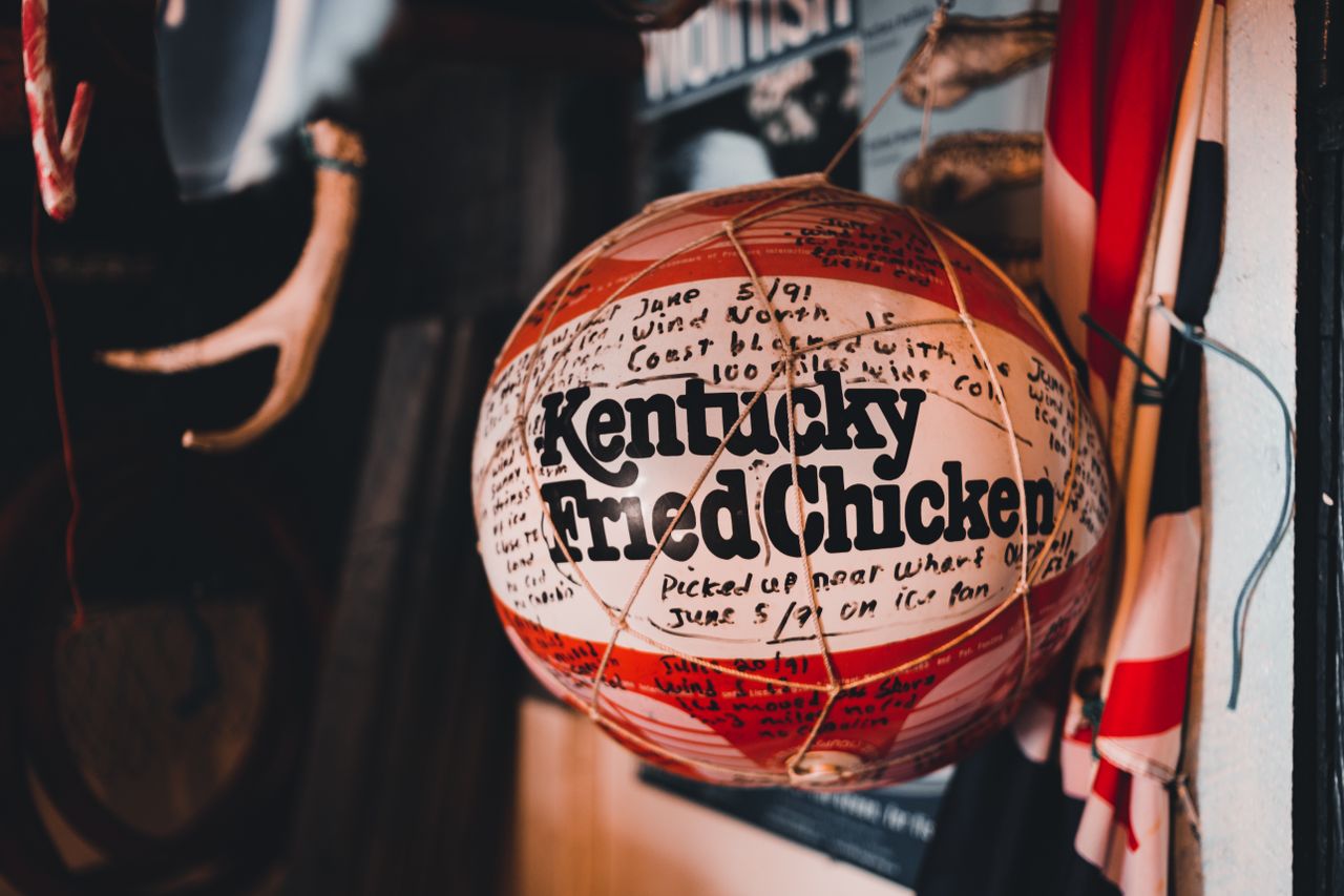 a vintage basketball with kentucky fried chicken branding hangs indoor