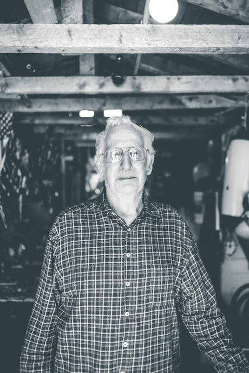 Grayscale Photo Of Man in Blue and White Plaid Button Up Shirt