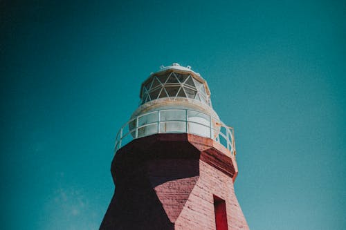 Low-Angle Shot of a Red and White Lighthouse