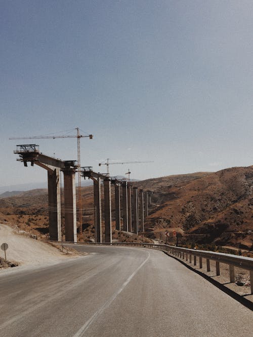 Gray Concrete Road Near a Bridge Construction 