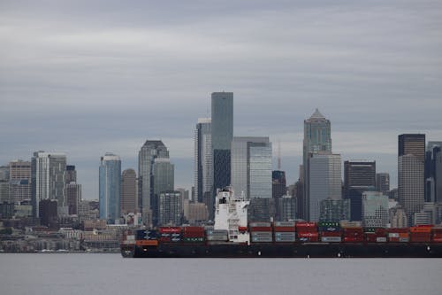 Free A Barge with Cargo Near Skyscrapers in Seattle, Washington, United States Stock Photo