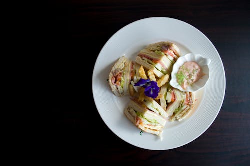 Free Sliced Clubhouse on Round White Ceramic Plate Stock Photo