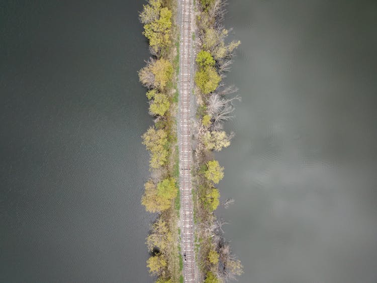 Aerial View Of Train Tracks Running Through Lake