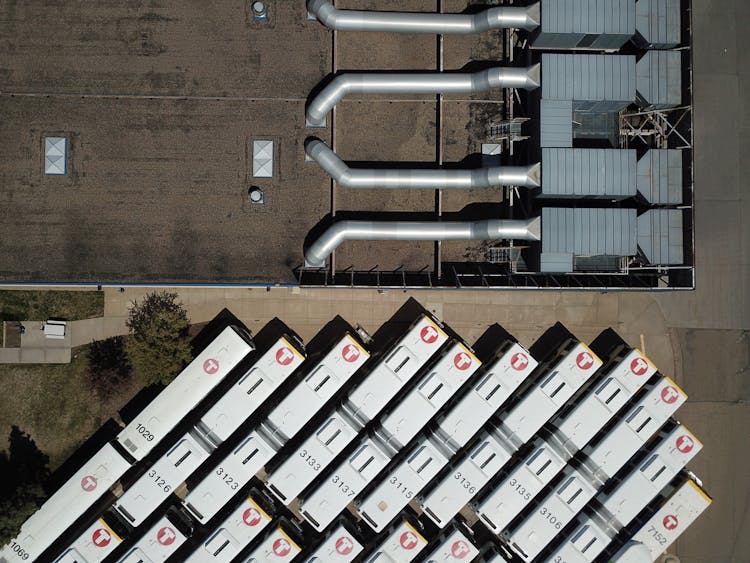 Aerial View Of Of Trucks Parked Near Factory Buil