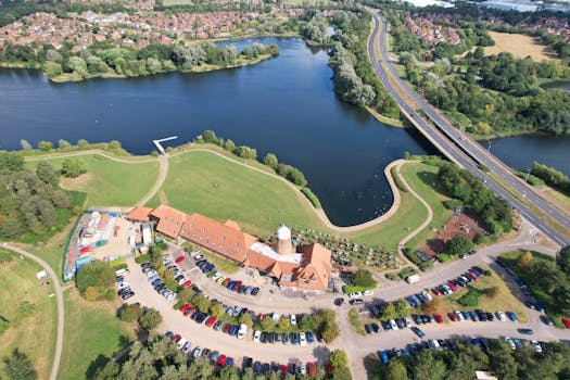 Drone shot capturing Caldecotte Lake and surrounding park in Milton Keynes, UK.