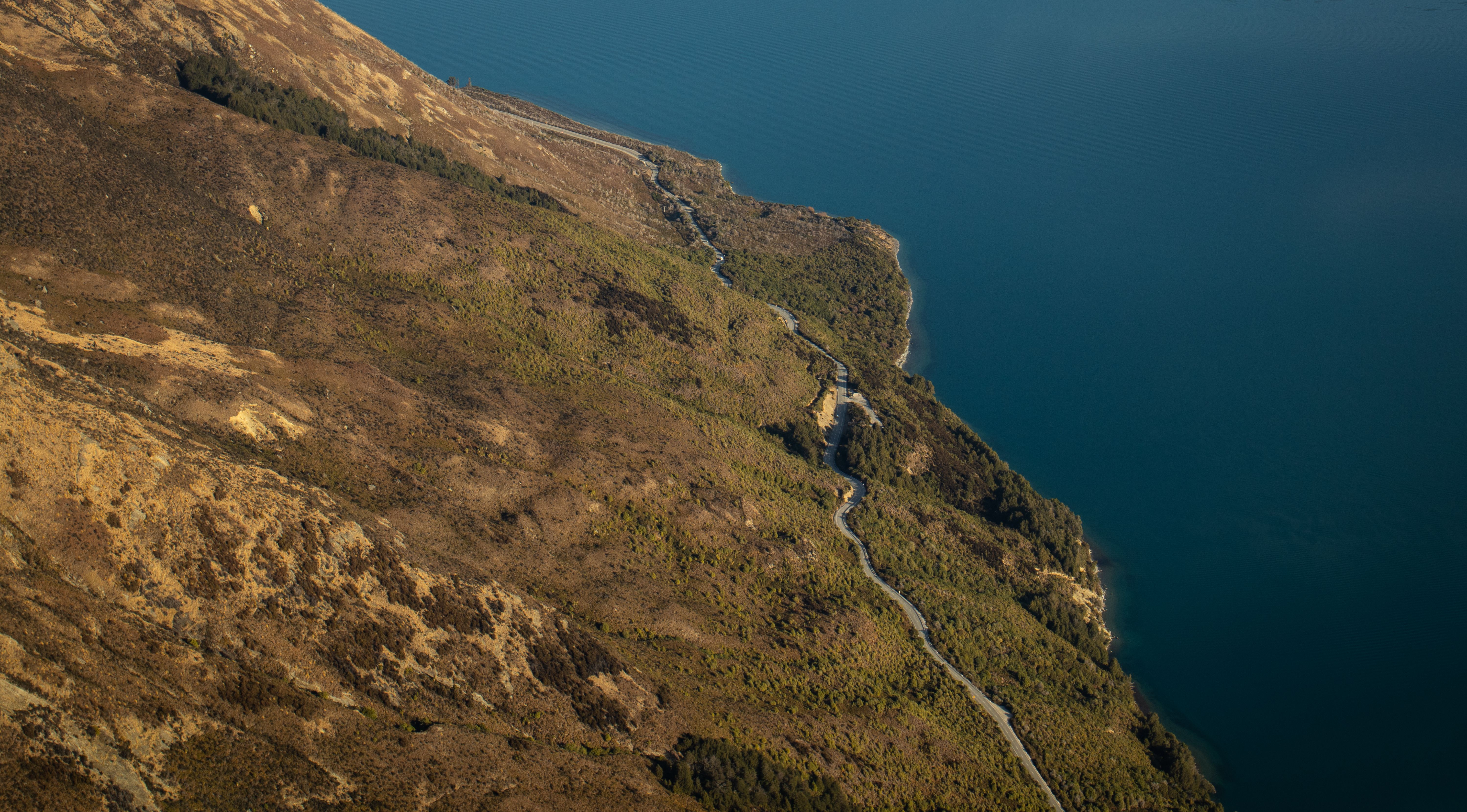 Amazing Milford Sound Helicopter Flight and Cruise from Queenstown Review Review 2026 - Scenic aerial view of Otago's coastline in New Zealand showcasing rugged terrain and tranquil waters.