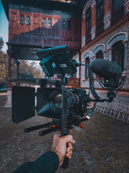 A Person Holding a Black Film Camera