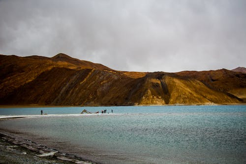 Free Body of Water With Mountain Ahead Stock Photo