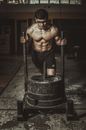 Topless Man in Black Pants Holding Black Metal Rod
