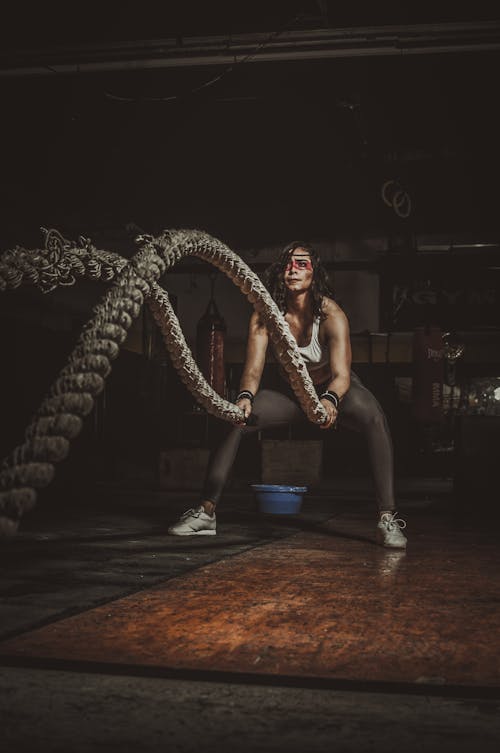 A Woman Exercising using Battle Ropes