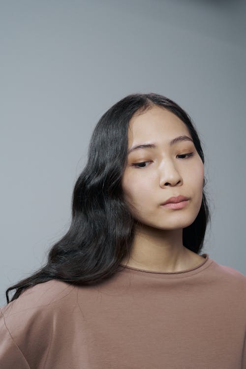 A Woman in a Brown Shirt Looking Down