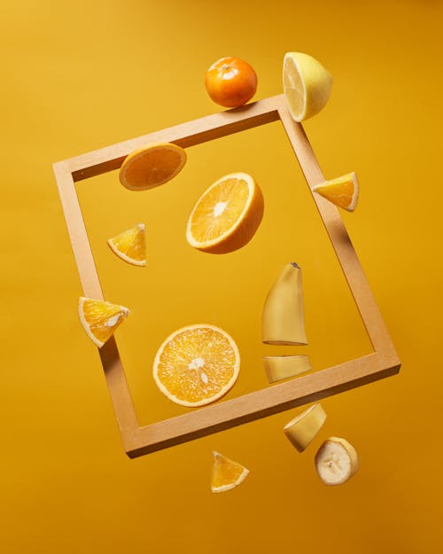 Free Photograph of Sliced Fruits Near a Wooden Frame Stock Photo