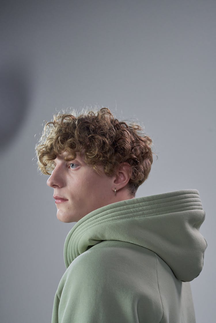 A Man In Hoodie Jacket With Curly Hair