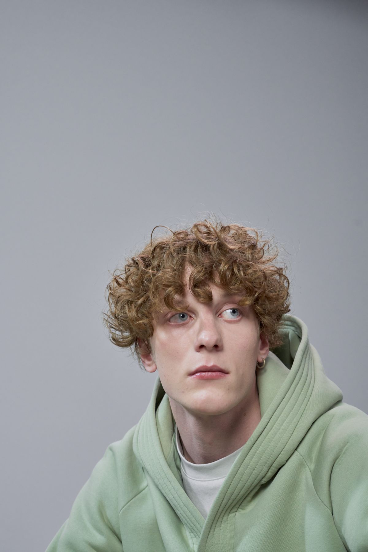 Man in a sage-green hoodie