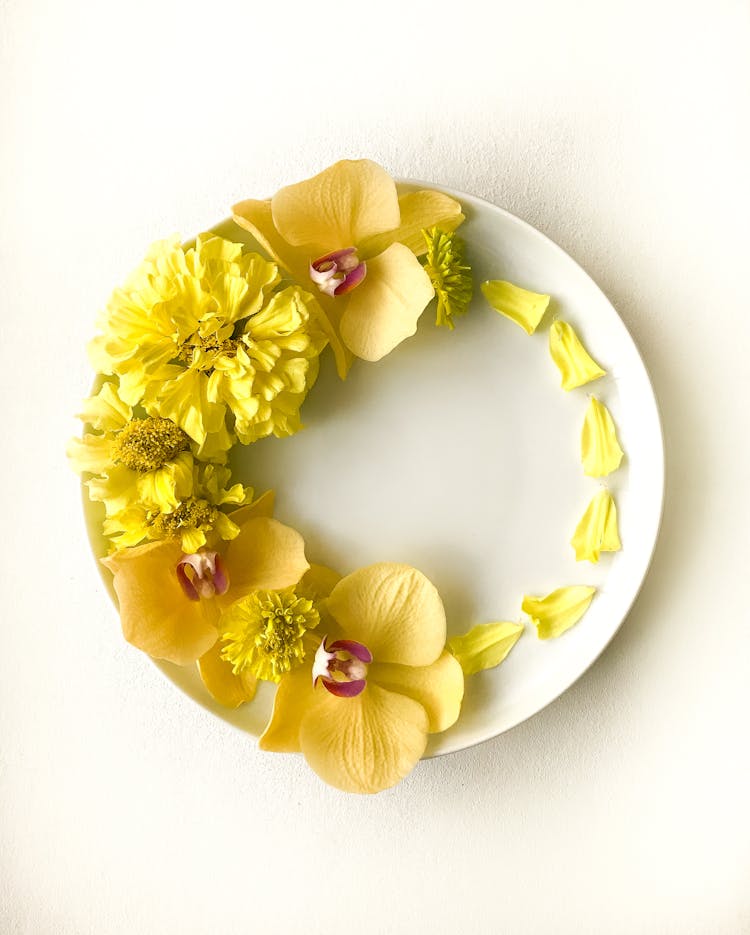 Overhead Shot Of Yellow Flowers On A Plate