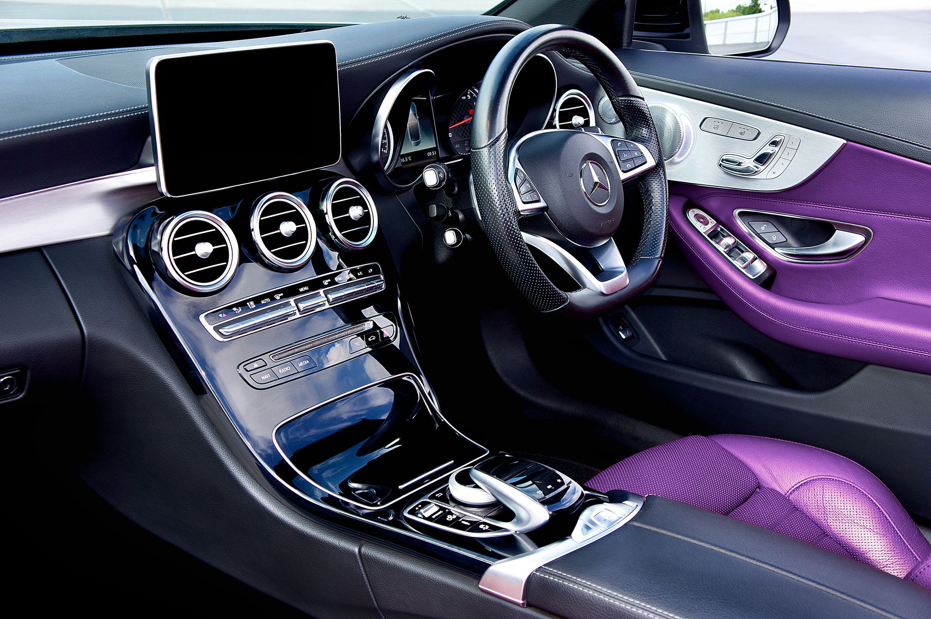 Sleek and modern Mercedes Benz interior featuring purple leather seats and digital dashboard display.