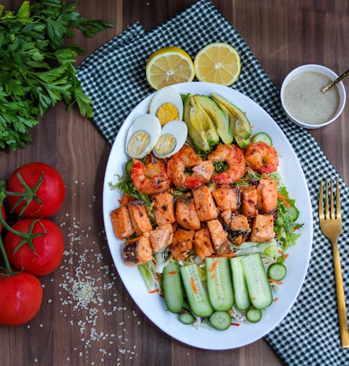 Cooked Shrimps and Meat on Top of Salad Served on Ceramic Platter