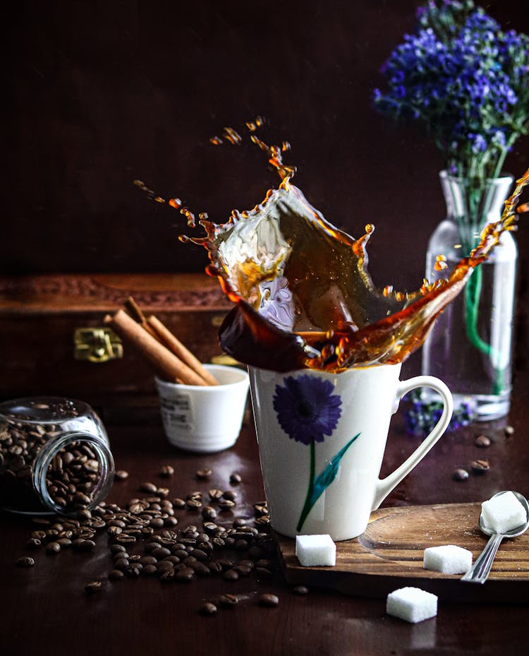 Coffee Splashing In Cup On Table