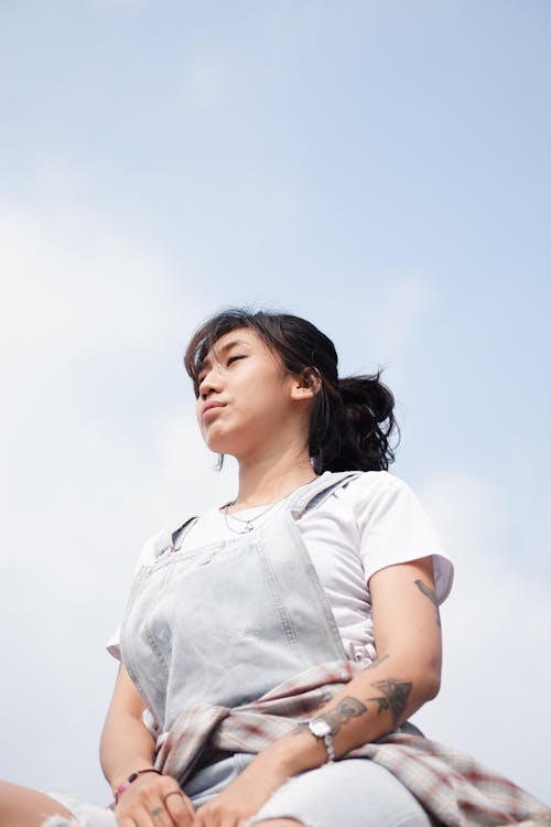 Low-Angle Shot of a Woman in Denim Jumper